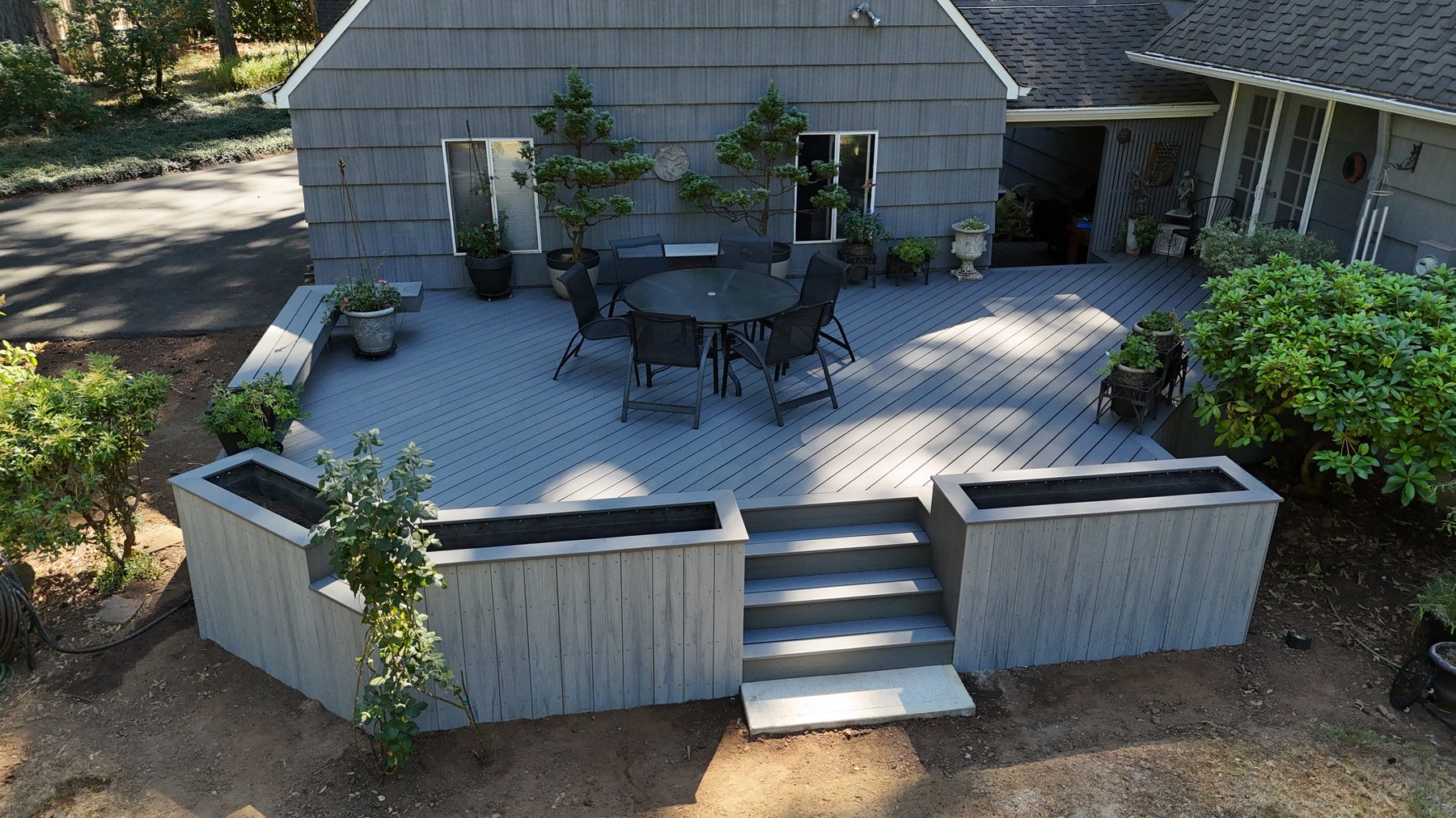 Aerial view of a finished custom deck with built-in planters and wide steps